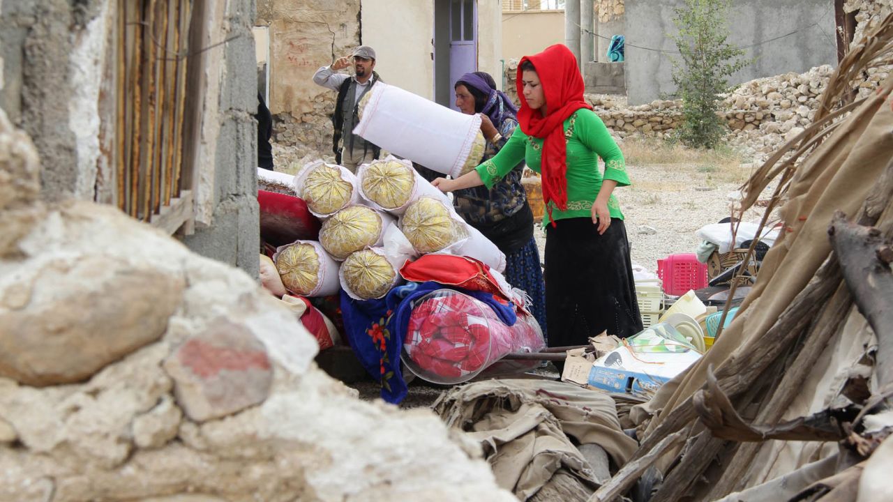 Villagers collect their belongings from the rubble in Shanbeh on April 10 after the quake.