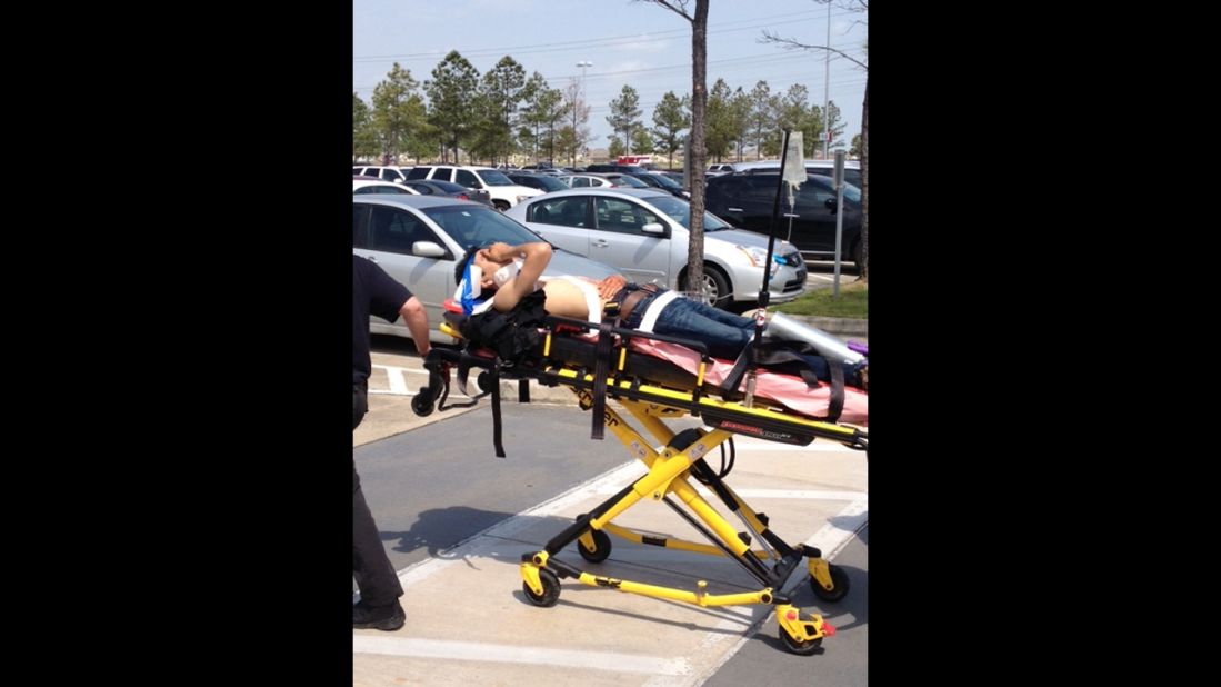 A victim is taken from the scene on a stretcher.