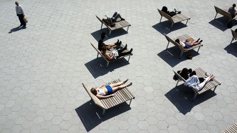 Warm spring weather finds New Yorkers relaxing along the East River in Lower Manhattan on Tuesday, April 9.