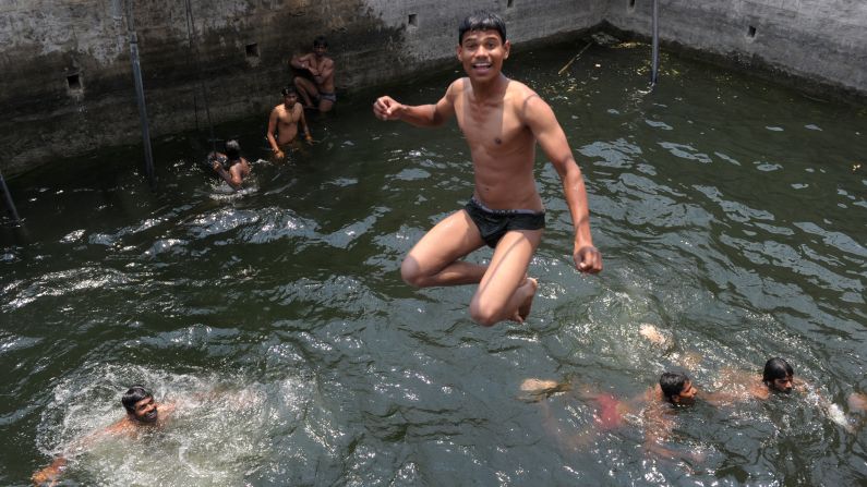 A youth jumps into a water well to cool off in Hyderabad, India, on Wednesday, April 10. 