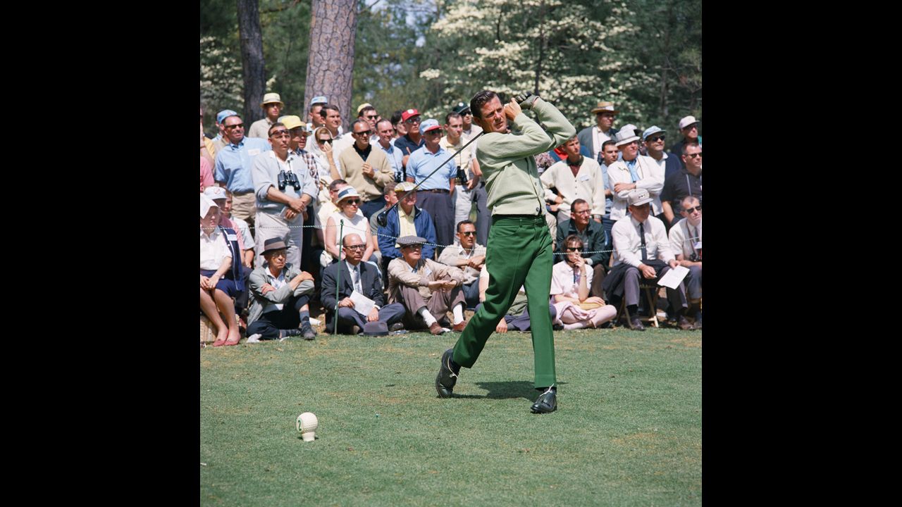 Doug Sanders, one of golf's earliest flamboyant dressers, tees off on the second hole during the 1966 Masters. His knack for lively fabrics earned him the nickname "Peacock of the Fairways."
