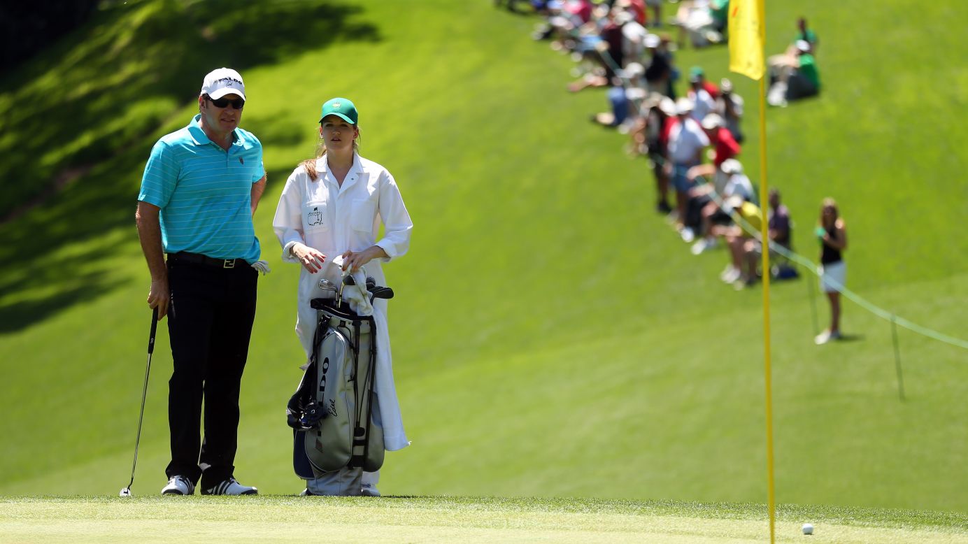 Nick Faldo of England stands with his daughter, Emma Scarlet, during the Par 3 Contest.