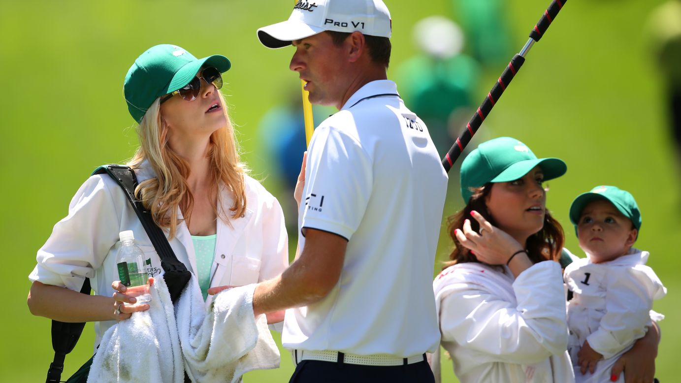 Webb Simpson of the U.S., center, speaks with his wife Dowd Simpson.