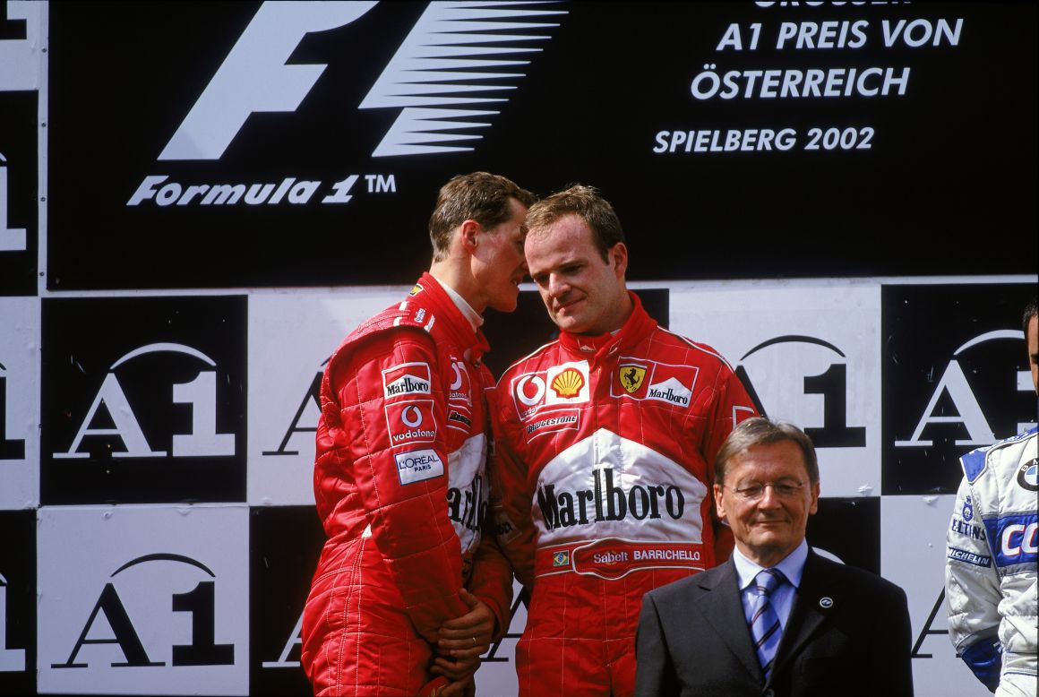 Rubens Barrichello (right) looks far from content as teammate Michael Schumacher has a quiet word on the podium following the 2002 Austrian Grand Prix, which the German controversially won. The Brazilian, who spent six years as Schumacher's deputy at Ferrari, says he empathizes with Webber's position at Red Bull. 