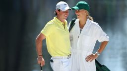 Rory McIlroy of Northern Ireland stands with his caddie Caroline Wozniacki during the Par 3 Contest prior to the start of the 2013 Masters Tournament at Augusta National Golf Club on April 10 in Augusta, Georgia.