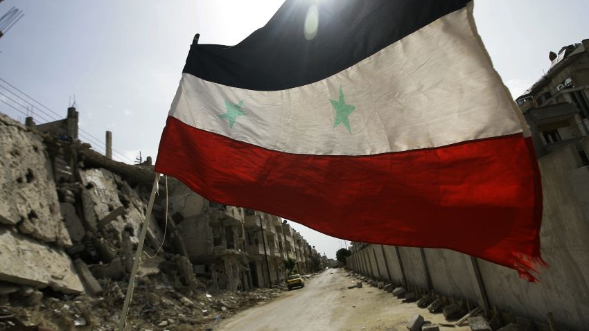 A Syrian flag flutters outside a military barrack in the devastated Bab Amro neighbourhood of the central restive city of Homs on May 2, 2012. The head of the UN mission to Syria said his observers were having a 'calming effect' on the ground but admitted the ceasefire was 'shaky' and not holding. AFP PHOTO/JOSEPH EID == THIS PICTURE WAS TAKEN ON AN OFFICIAL GOVERNMENT-GUIDED TOUR == (Photo credit should read JOSEPH EID/AFP/GettyImages) 