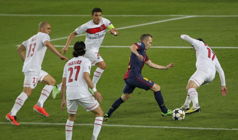 Andres Iniesta is surrounded by PSG defenders during a frantic first half at Camp Nou. Both teams pushed forward in a contest played at rapid pace.