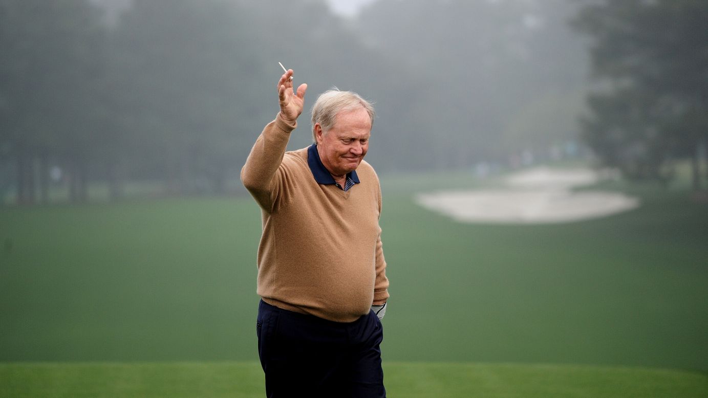 Honorary starter Jack Nicklaus waves to patrons after he tees off to start the first round.