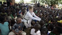 US Pop Star Madonna (C) interacts with Malawian children at Mkoko Primary School on April 2, 2013 in the region of Kasungu, central Malawi, one of the schools Madonna's Raising Malawi organization has built jointly with US organization BuildOn.