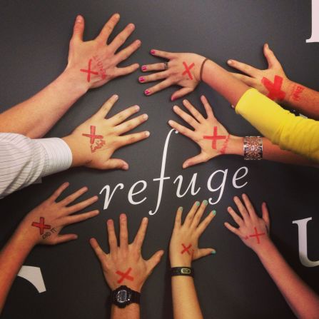 <a href="http://ireport.cnn.com/docs/DOC-953490">Katelyn Boyd</a>, a high school Bible teacher, and her students circled their hands around the word "Refuge," which is part of a mural wall in their classroom. "I wanted to make my high school students aware of the fact that slavery still exists and that THEY can do something to stop it...right now, where they are," she says.