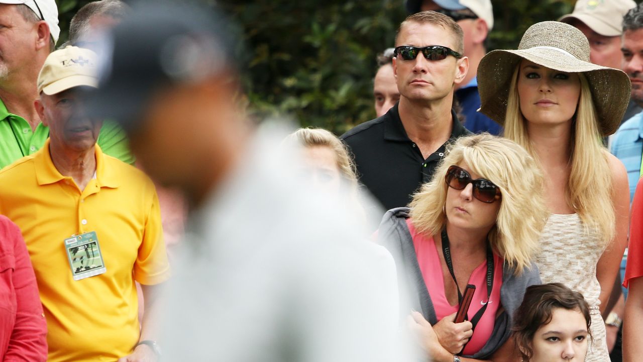 Skier Lindsey Vonn watches Tiger Woods play the first hole. Vonn and Woods have said they are dating. 