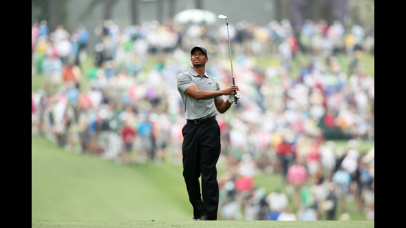Tiger Woods hits a shot on the first hole.