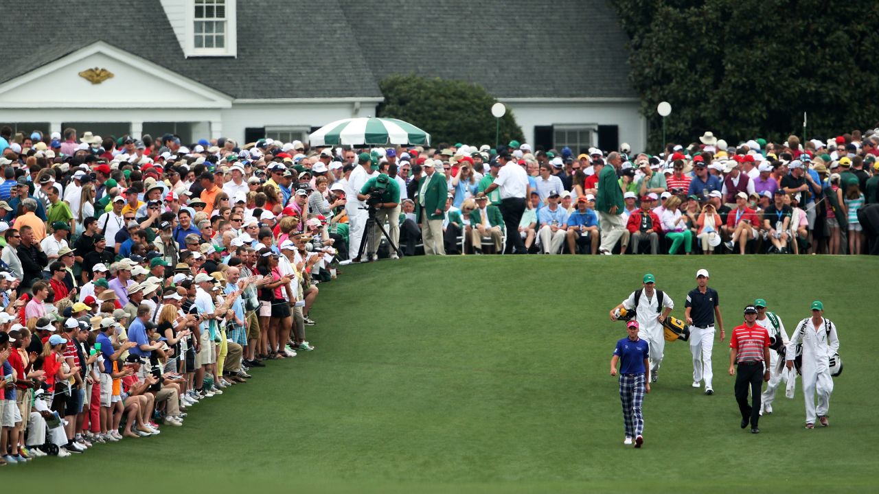 Left to right: Ian Poulter of England, Steven Fox and Bubba Watson of the U.S. walk up the fairway on the first hole.