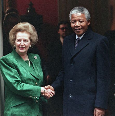[File photo] South African anti-apartheid leader and African National Congress (ANC) member Nelson Mandela (R) shakes hands with then British Prime Minister Margaret Thatcher on the steps of 10 Downing Street on July 4, 1990. Mandela has turned down his invitation.