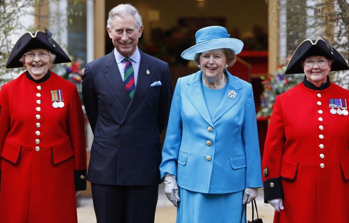 [File photo] Prince Charles and his wife, Camilla, Duchess of Cornwall will also miss the funeral proceedings. In this 2009 photo, Prince Charles and Margaret Thatcher pose with Chelsea pensioners as they attend the opening of a new infirmary at the Royal Hospital Chelsea in London.