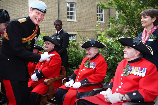 [File photo] Prince Charles' youngest son, Prince Harry, will also not be attending. Here, he talks with In-Pensioners at the Margaret Thatcher Infirmary at the Royal Hospital Chelsea on June 9, 2011, in London.