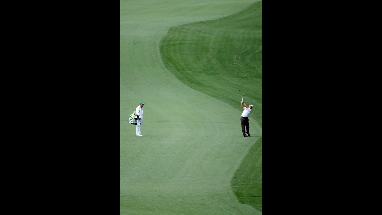 Phil Mickelson of the U.S. hits his second shot on the 10th hole.