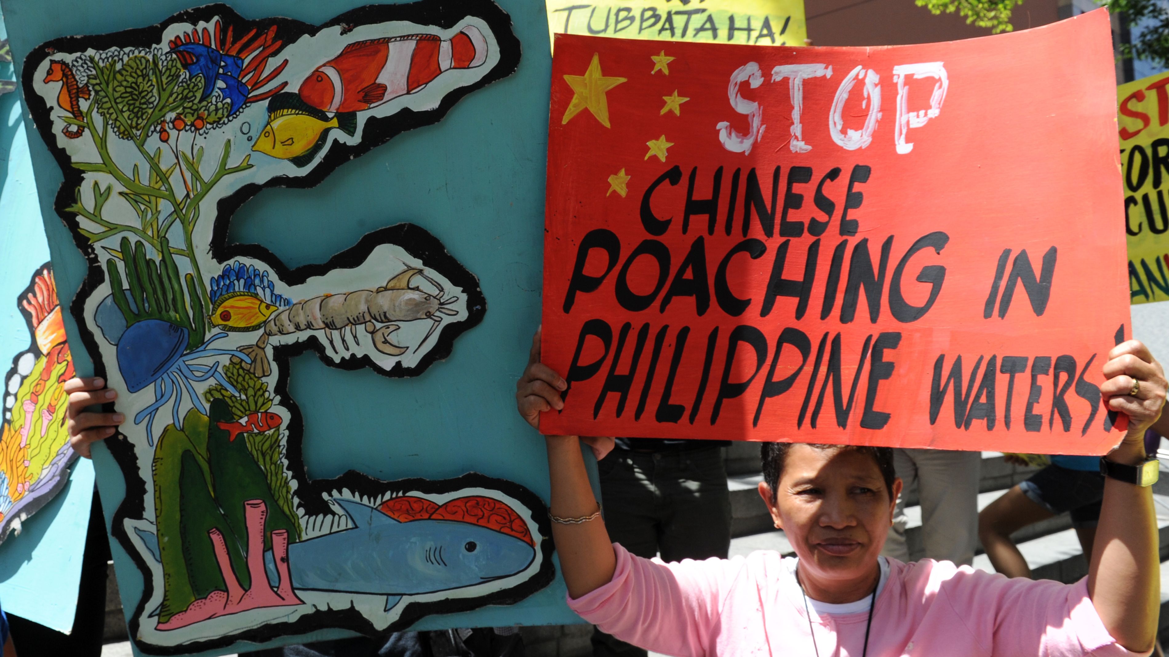 Protesters display placards during a rally in front of the Chinese consular office in Manila on April 11.