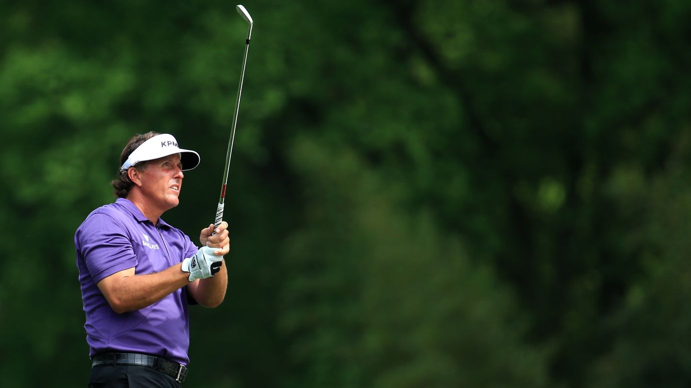 Phil Mickelson of the U.S. hits a shot on the fifth hole.
