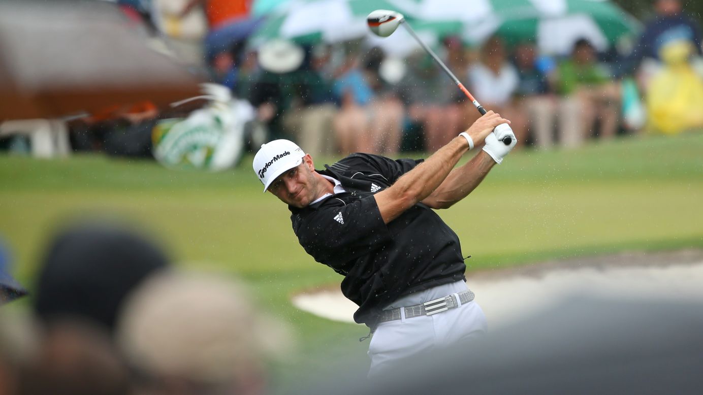 Dustin Johnson of the U.S. hits a shot on the third hole.