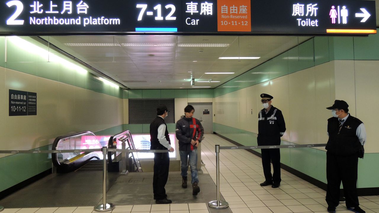 A passenger walks past the closed off area at Taoyuan High Speed Rail Station on April 12, 2013 after two suspected explosives and triggering devices found on the train.