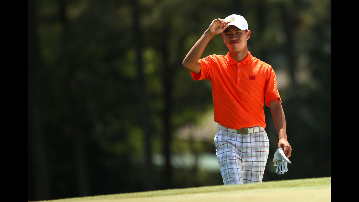 Tianlang Guan of China walks up the 18th fairway during the second round. Guan was given a one-shot penalty following his second shot on the 17th hole for exceeding the 40-second time limit.
