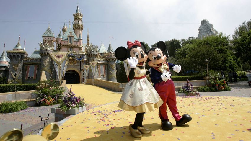 Disney characters Mickey Mouse and Minnie wave to a crowd of people in front the Sleeping Beauty Castle during the 50th anniversary of the opening of Disneyland  in Anaheim, California, 17 July 2005. California's Governor Arnold Schwarzenegger, Disney CEO Michael Eisner, his designated successor Robert Iger and other personalities attended the event. AFP PHOTO/Hector MATA        (Photo credit should read HECTOR MATA/AFP/GettyImages)