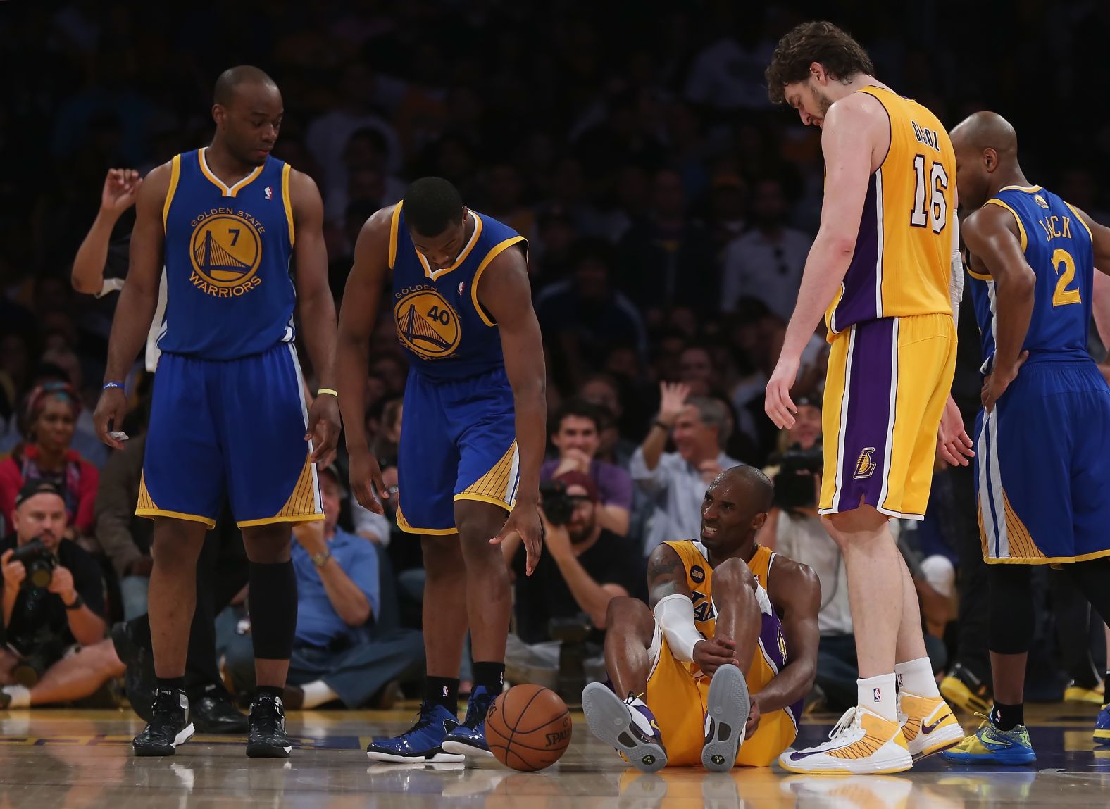 Bryant is injured in the second half while playing the Golden State Warriors in 2013. The injury took him out of the rest of the season.