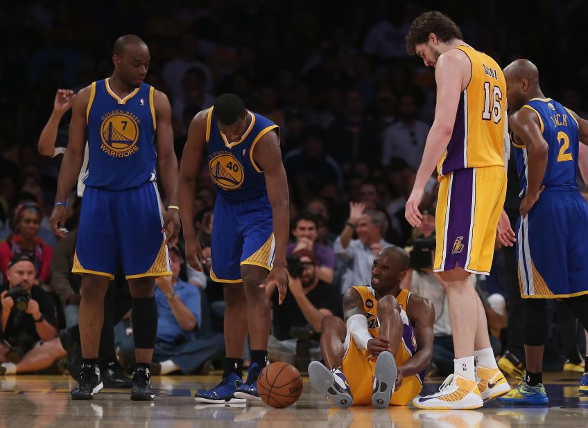 Bryant is injured in the second half while playing the Golden State Warriors in 2013. The injury took him out of the rest of the season.