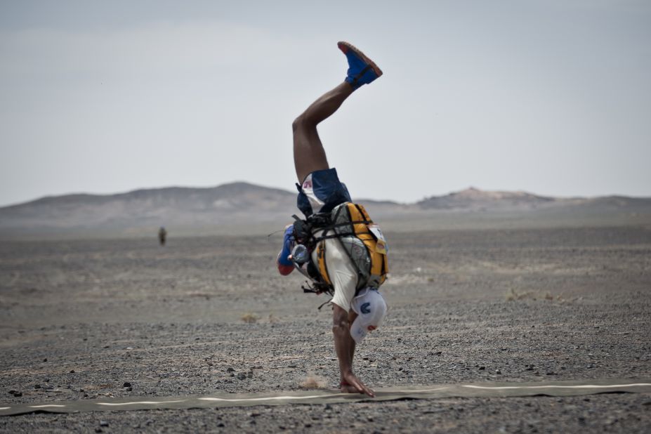 Moroccan Mohamad Ahansal crosses the line with a cartwheel to be crowned winner of this year's Marathon des Sables (MDS).