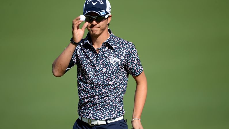 Ryo Ishikawa of Japan waves after making par on the second hole.