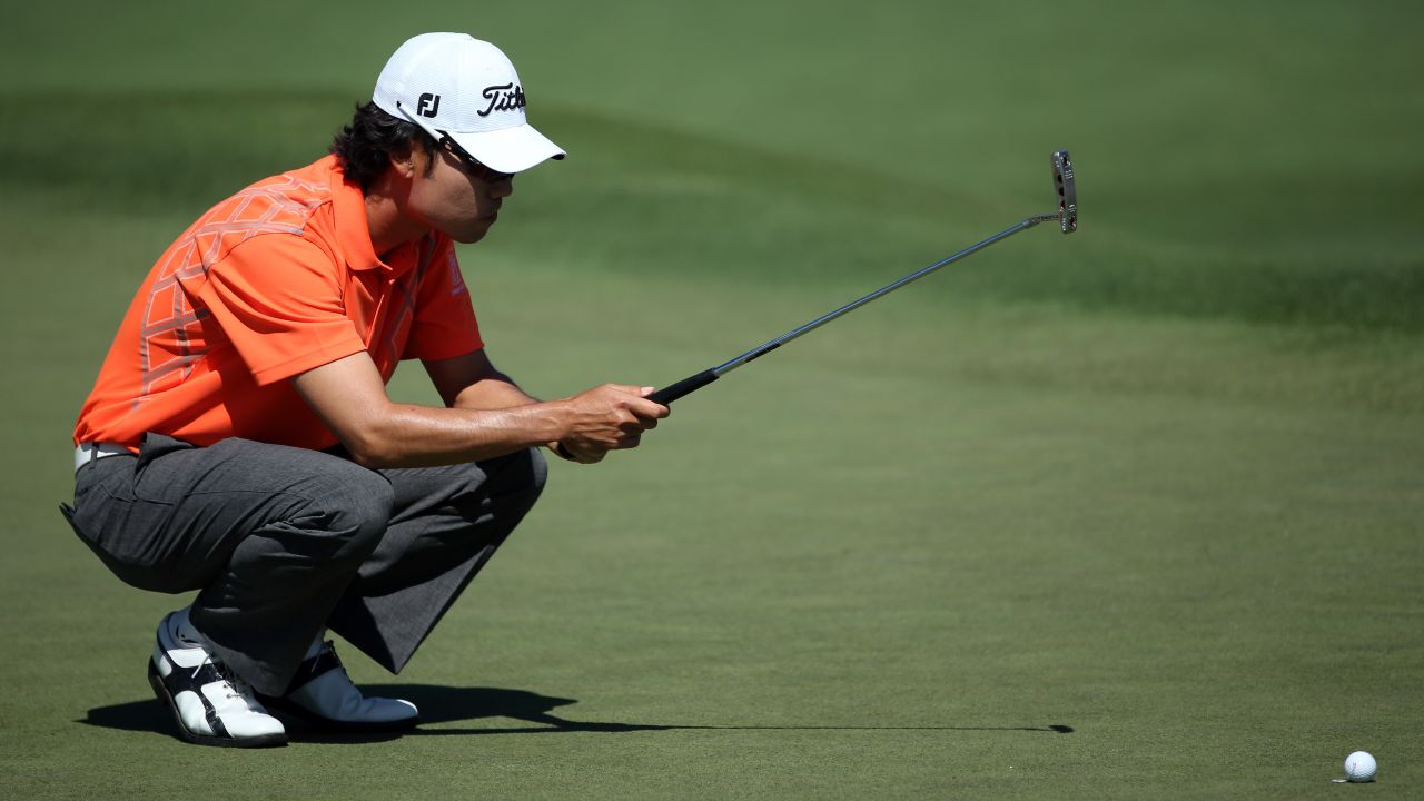 Kevin Na of the U.S. lines up a putt on the second hole.