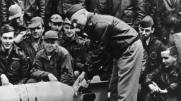 Lt. Col. James Doolittle leans over a bomb on the USS Hornet deck just before his "Raiders" began the bombing raid on Tokyo. 