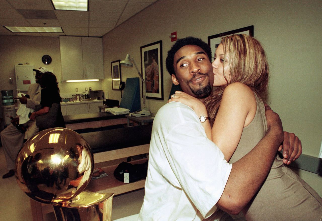 Bryant hugs his fiancee, Vanessa Laine, in the locker room in Los Angeles after the Lakers defeated the Indiana Pacers in Game 6 of the 2000 NBA Finals to win the series 4-2. Bryant later married Laine, and they had four children.