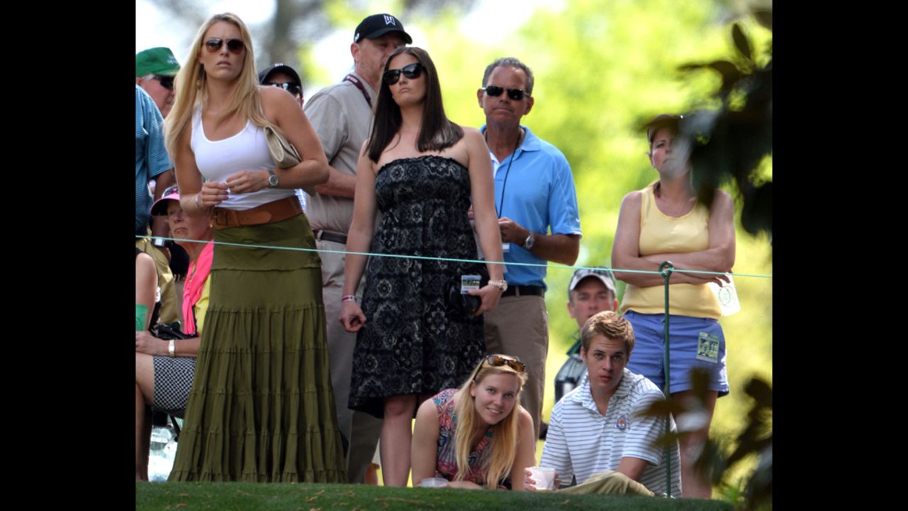 Lindsey Vonn watches Tiger Woods of the United States.