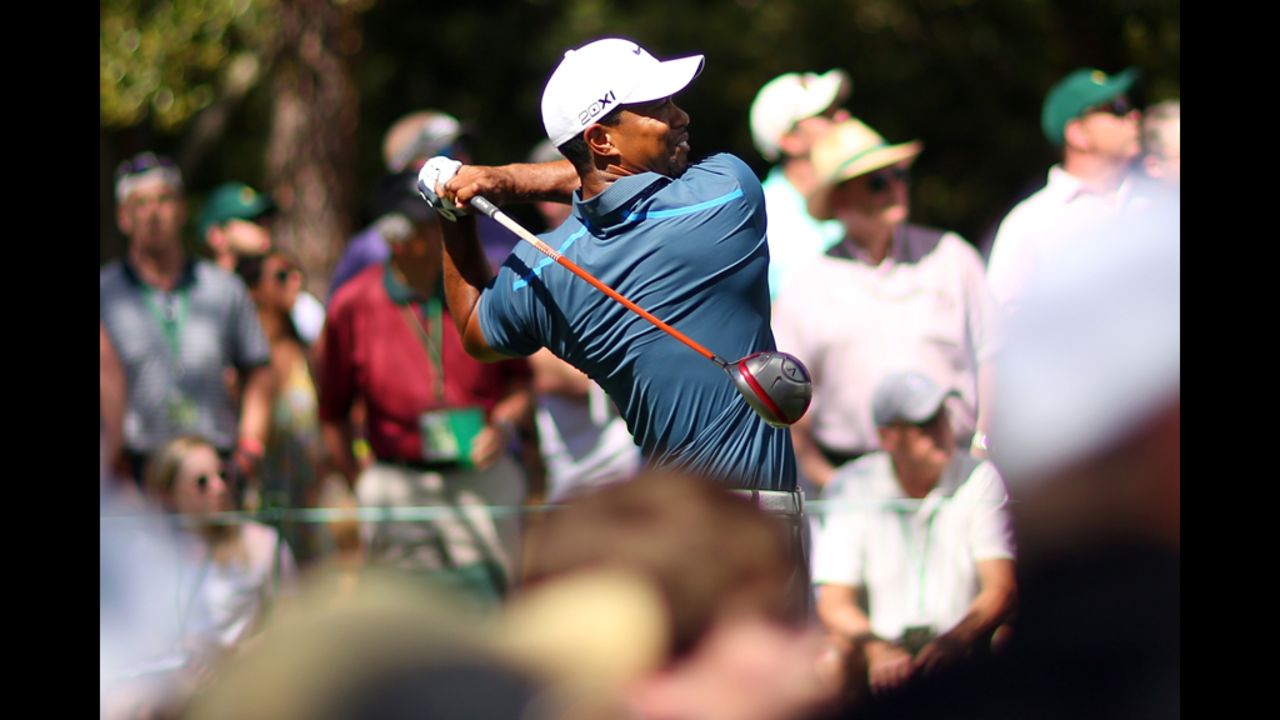 Tiger Woods hits a tee shot on the ninth hole.