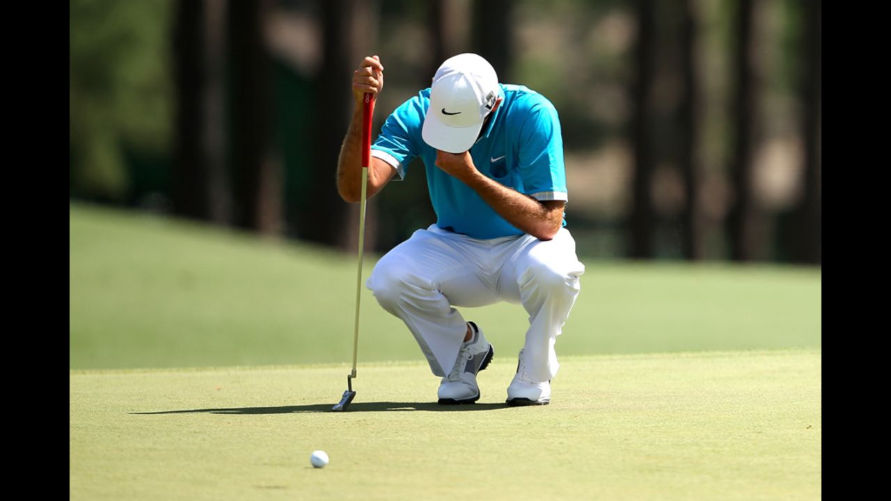 Charl Schwartzel of South Africa reacts after missing a birdie putt on the eighth hole.