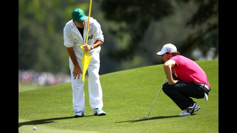 Rory McIlroy of Northern Ireland lines up a putt on the eighth hole.