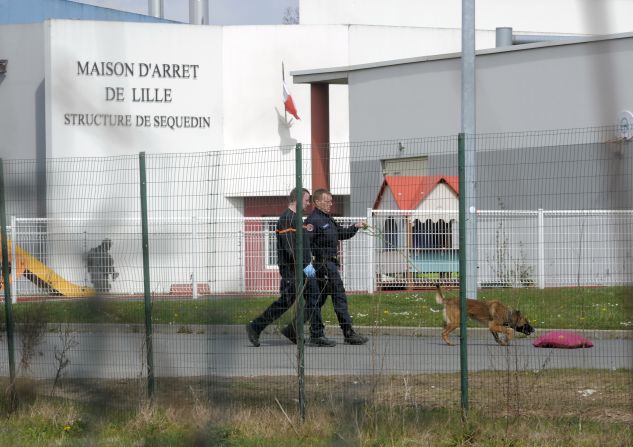 Policemen search for clues in the prison yard. Faid, who faced a heavy sentence in the 2010 death of a policewoman, used explosives to blast through five prison doors.
