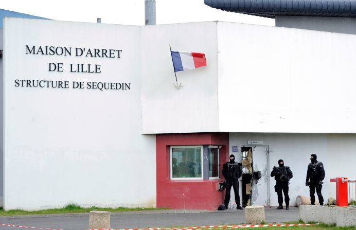 Members of the ERIS Police service guard the destroyed  prison door.