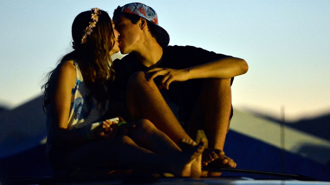 Two festivalgoers kiss at the Empire Polo Field before the 2013 <a href="http://www.coachella.com/index.php" target="_blank" target="_blank">Coachella Valley Music and Arts Festival</a> in Indio, California, on Thursday, April 11.