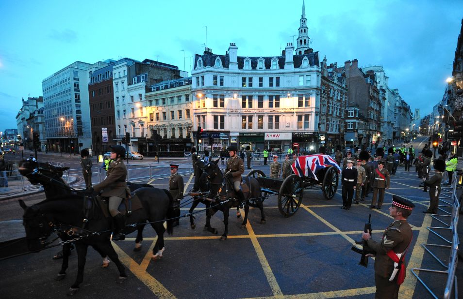 A Gun Carriage of the King's Troop Royal Horse Artillery carrying a coffin passes through Ludgate Circus.