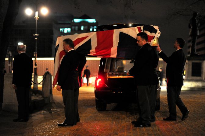 Pallbearers carry a coffin into St Clement Danes church during the rehearsal.