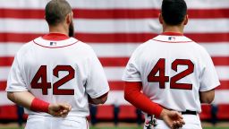 Jonny Gomes, left, and Jacoby Ellsbury, right, look on during the national anthem prior to a game against the Tampa Bay Rays at Fenway Park on Monday, April 15 in Boston. All Major League Baseball uniformed team members are wearing jersey number 42 in honor of Jackie Robinson Day.