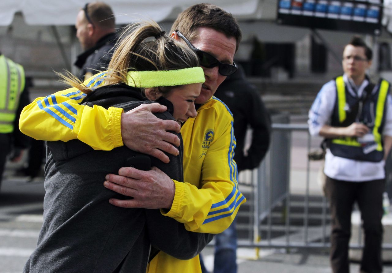 A woman is comforted after the blasts.