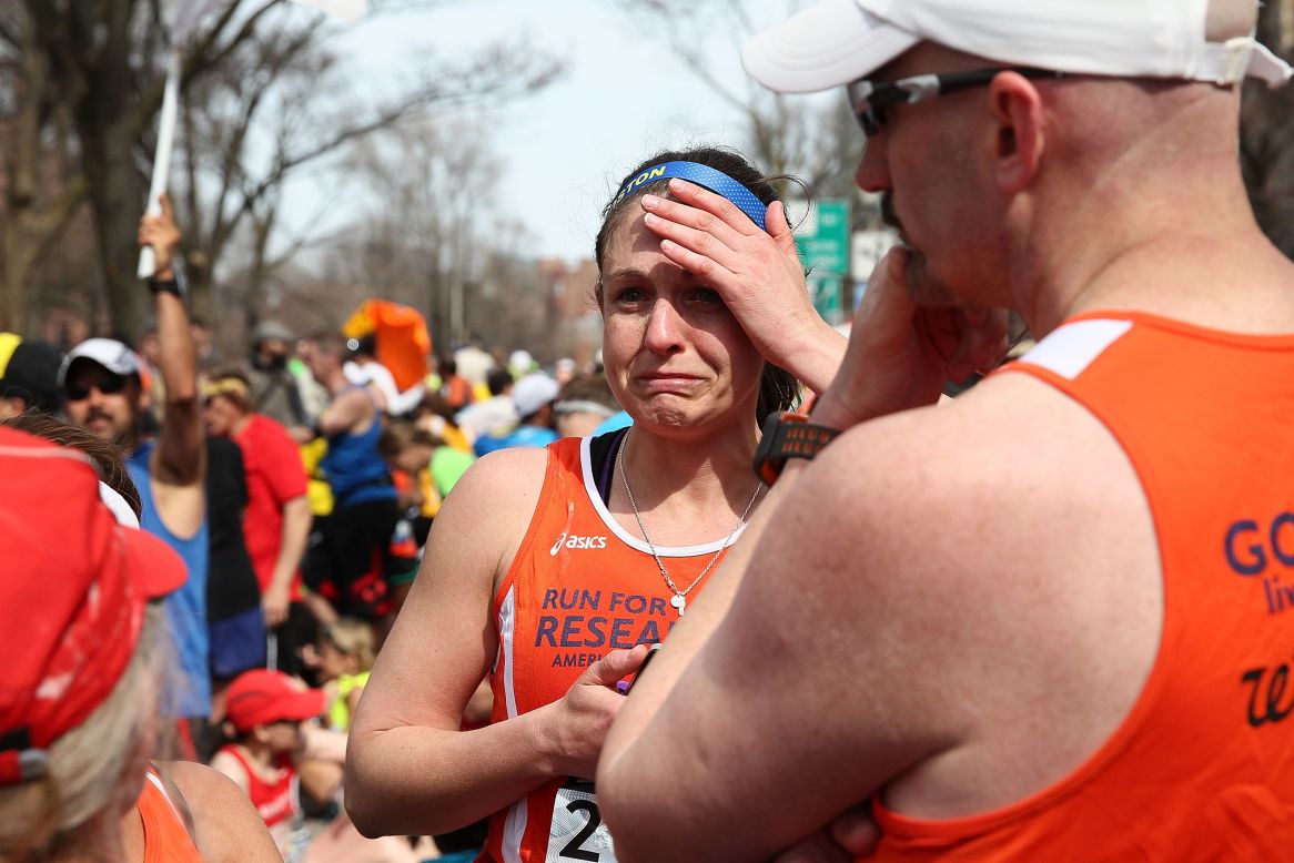 Runners react near Kenmore Square after the explosions.