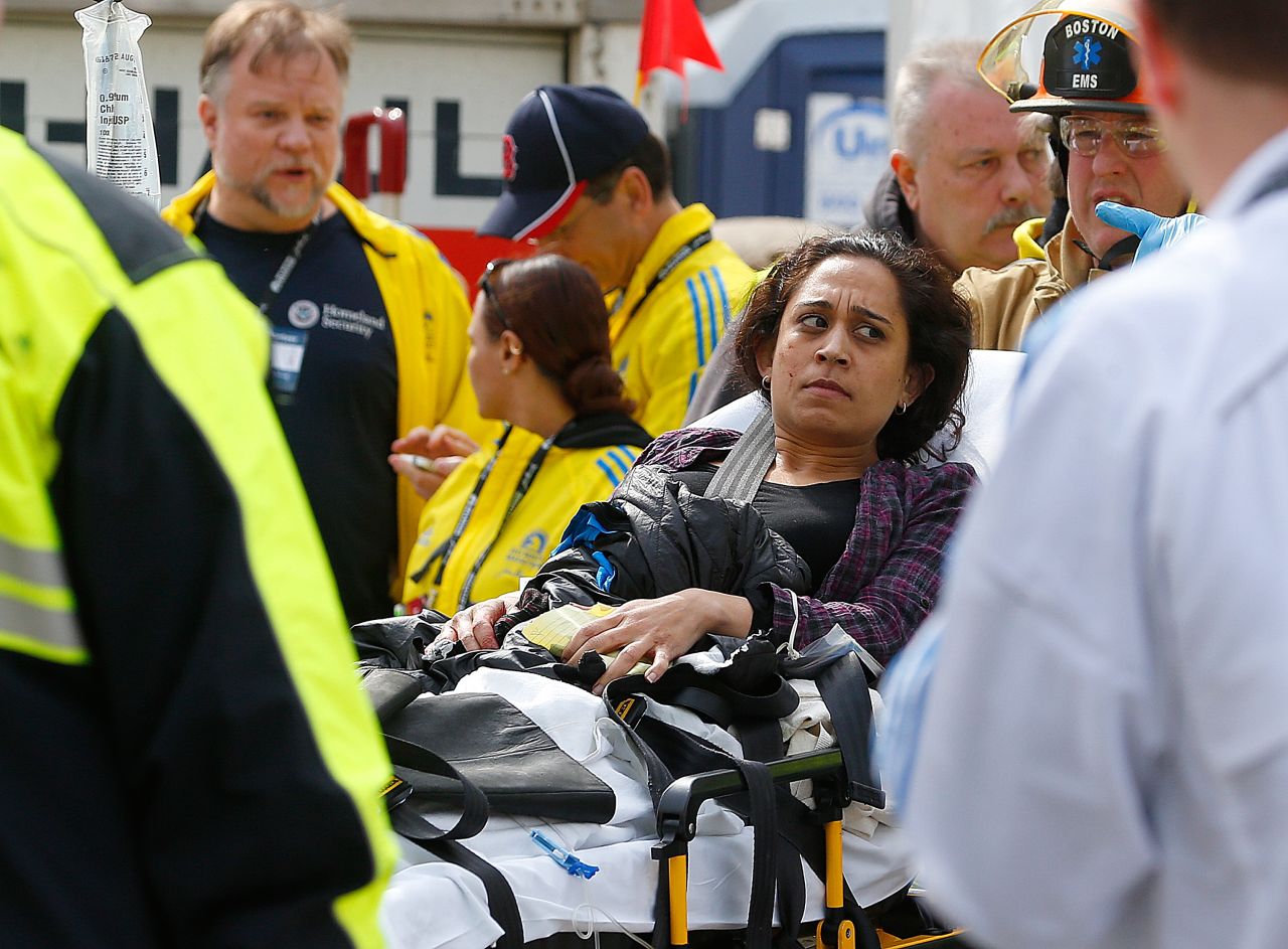 An injured woman is loaded into an ambulance.
