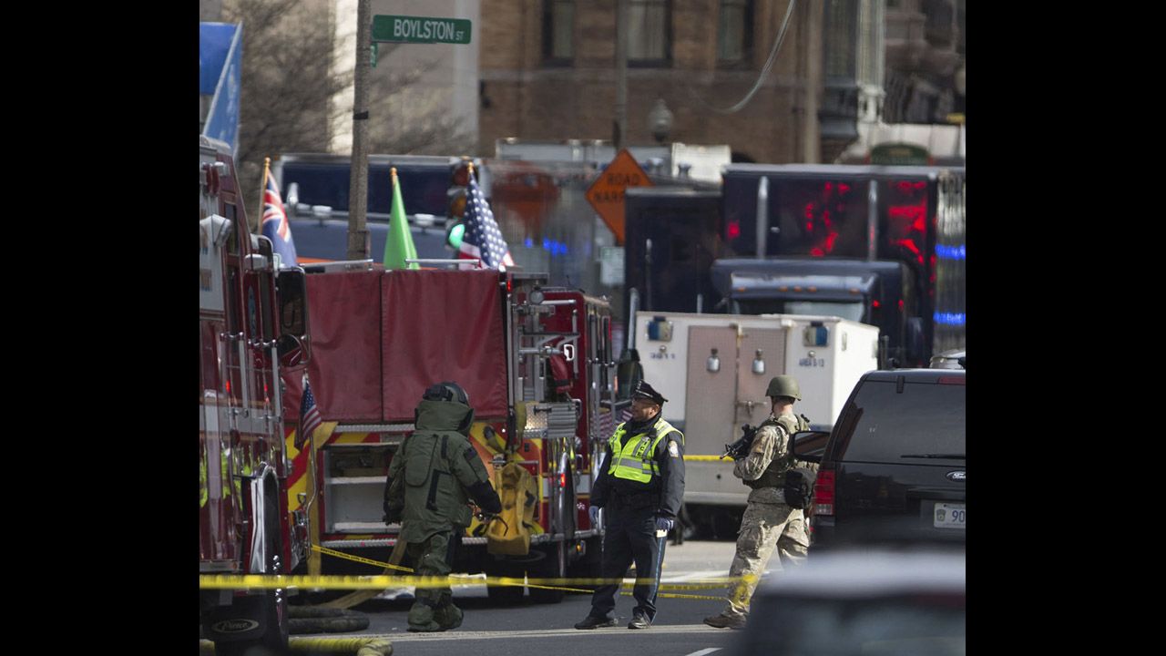 Bomb squad officials check a possible suspicious device near the scene of the blasts.