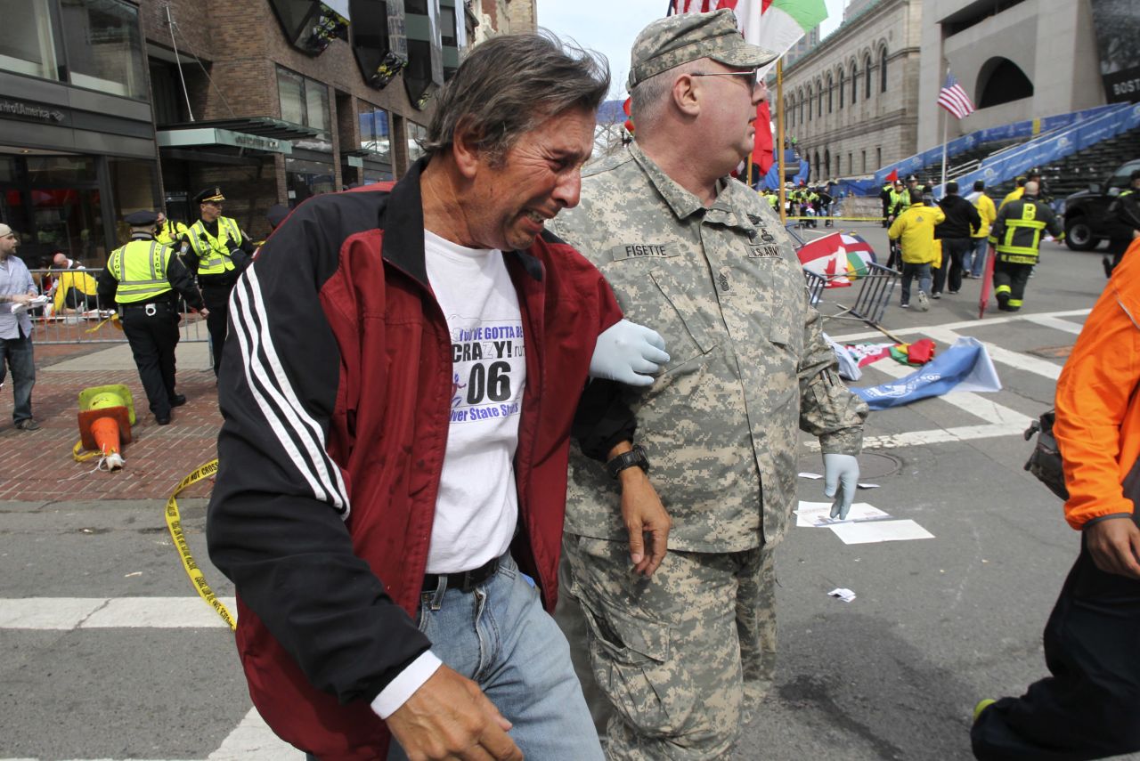 A man in tears is helped at the scene on Boylston Street.