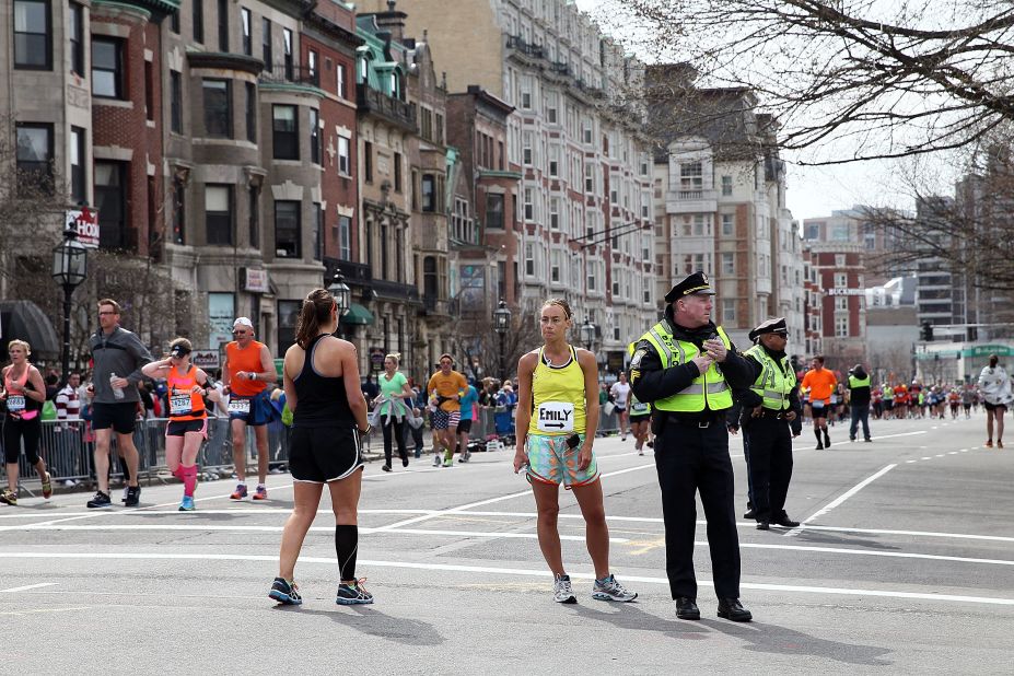 Police and runners stand near Kenmore Square after the attack.